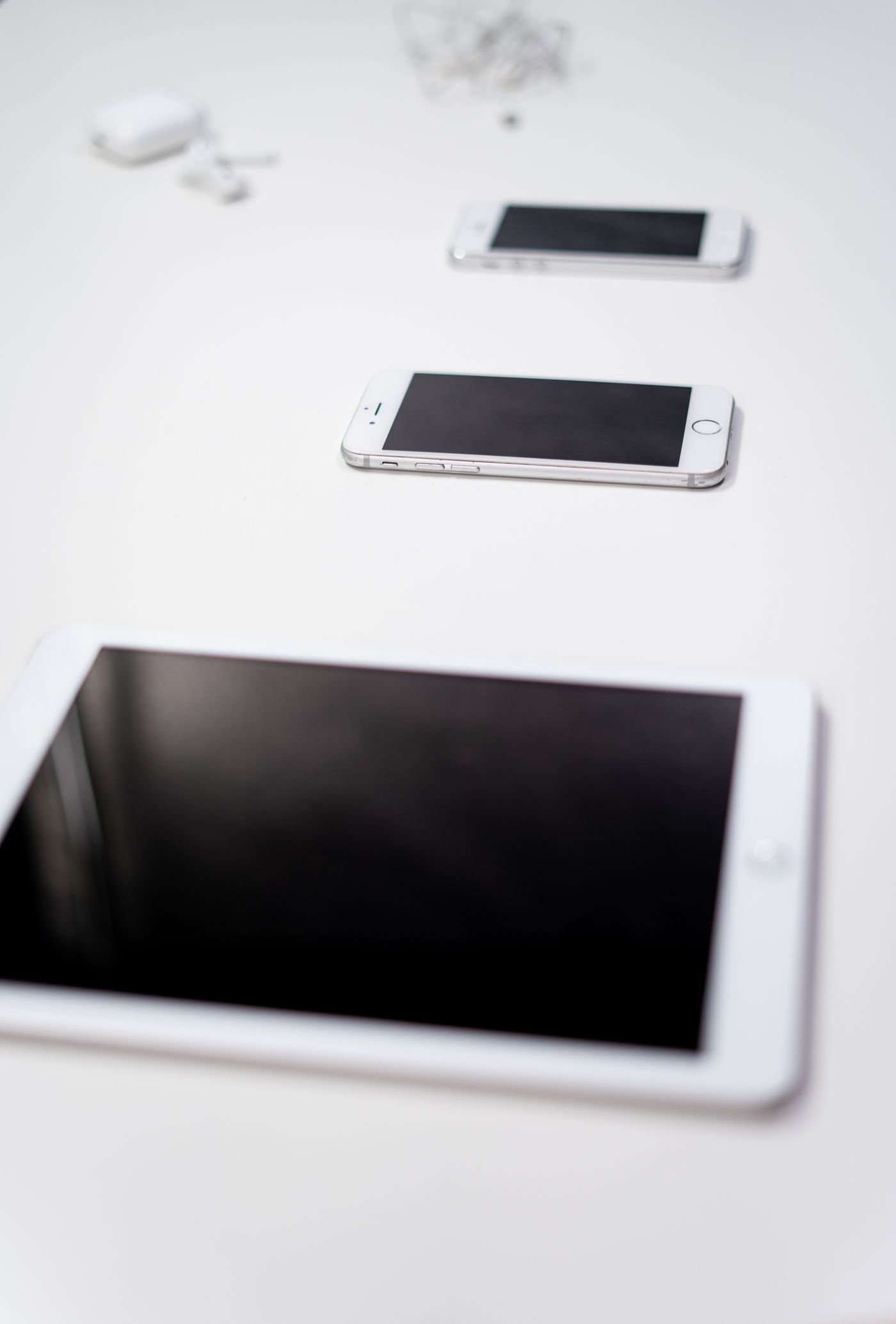 Tablets and smartphones arranged on a white background